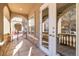 Covered porch showcasing arched entry and decorative pillars leading to double glass entry doors at 40 Madison St # 103, Denver, CO 80206