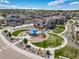 Aerial view of neighborhood featuring walking paths, playground, green spaces, and well-maintained homes at 476 Hyde Park Cir, Castle Pines, CO 80108