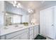 Bathroom featuring a double vanity, large mirror, and modern fixtures at 476 Hyde Park Cir, Castle Pines, CO 80108