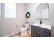 Bathroom features a modern vanity, stylish mirror, and sleek fixtures at 476 Hyde Park Cir, Castle Pines, CO 80108