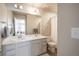 Well-lit bathroom featuring double sinks, white cabinets, a large mirror, and a shower with curtain at 476 Hyde Park Cir, Castle Pines, CO 80108