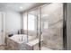 Bright bathroom with a large soaking tub, tiled shower, and large window at 476 Hyde Park Cir, Castle Pines, CO 80108