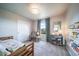 Cozy bedroom features carpet flooring, large window, and closet at 476 Hyde Park Cir, Castle Pines, CO 80108