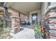 Inviting front porch featuring stone pillars, cozy seating, and decorative string lights for relaxing evenings at 476 Hyde Park Cir, Castle Pines, CO 80108