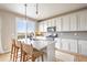 Stylish kitchen with an island, granite countertops, stainless steel appliances, and scenic outdoor views at 476 Hyde Park Cir, Castle Pines, CO 80108