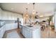 Open kitchen featuring stainless steel appliances, granite countertops, and seamless flow to dining and living areas at 476 Hyde Park Cir, Castle Pines, CO 80108