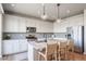 Modern kitchen featuring granite countertops, stainless steel appliances, and an island with bar seating at 476 Hyde Park Cir, Castle Pines, CO 80108