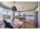 Open concept kitchen with an island, modern appliances, and large view windows at 476 Hyde Park Cir, Castle Pines, CO 80108