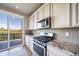 Well-equipped kitchen featuring stainless steel appliances, granite countertops, and access to an outdoor deck at 476 Hyde Park Cir, Castle Pines, CO 80108