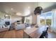Open-concept living room featuring a fireplace, dining area, and lots of natural light at 476 Hyde Park Cir, Castle Pines, CO 80108