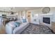 Open-concept living room with a fireplace, neutral tones, and seamless flow to the dining and kitchen area at 476 Hyde Park Cir, Castle Pines, CO 80108