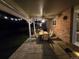 Covered back patio with outdoor seating, ceiling fan, and string lights on a stone surface at 7782 S Louthan St, Littleton, CO 80120