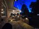 Back patio with brick features, dining set, grill, and soft lighting for evening enjoyment at 7782 S Louthan St, Littleton, CO 80120
