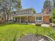 Spacious backyard with a fire pit, patio seating and lush lawn at 7782 S Louthan St, Littleton, CO 80120
