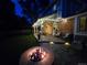 Inviting backyard patio with a fire pit, outdoor seating, and string lights for evening ambiance at 7782 S Louthan St, Littleton, CO 80120