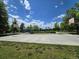 Outdoor basketball court with playground equipment, benches, and vibrant green spaces for community enjoyment at 7782 S Louthan St, Littleton, CO 80120