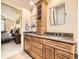 Well-appointed bathroom with double vanity, granite countertops, and ample storage for convenience at 7782 S Louthan St, Littleton, CO 80120