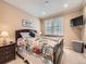 Comfortable bedroom with neutral tones, plantation shutters, and a cozy quilt on the bed at 7782 S Louthan St, Littleton, CO 80120