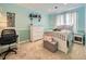 Light-filled bedroom with light-blue walls, white furniture and light-colored carpet at 7782 S Louthan St, Littleton, CO 80120