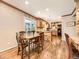 Spacious dining area with hardwood floors, adjacent to the kitchen and a view of the screened-in patio at 7782 S Louthan St, Littleton, CO 80120