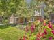 Charming home with a well-manicured front yard and beautiful landscaping at 7782 S Louthan St, Littleton, CO 80120