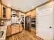 Modern kitchen featuring stainless steel appliances, granite countertops, custom cabinetry and hardwood floors throughout the space at 7782 S Louthan St, Littleton, CO 80120