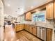 Spacious kitchen with granite countertops, stainless steel appliances, custom cabinets and hardwood floors at 7782 S Louthan St, Littleton, CO 80120
