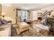 Inviting living room with hardwood floors, large windows, and cozy seating at 7782 S Louthan St, Littleton, CO 80120