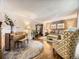 Cozy living room boasts a piano, hardwood floors, and elegant furnishings for a comfortable space at 7782 S Louthan St, Littleton, CO 80120