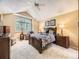 Cozy main bedroom with a ceiling fan, large window, and comfortable furnishings at 7782 S Louthan St, Littleton, CO 80120