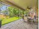 Charming covered patio with outdoor seating and a ceiling fan, perfect for entertaining at 7782 S Louthan St, Littleton, CO 80120