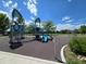 Modern playground with climbing structures and slides set against a backdrop of lush green fields at 7782 S Louthan St, Littleton, CO 80120