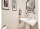 Elegant powder room showcasing pedestal sink, stylish fixtures, and tasteful decor for a sophisticated touch at 7782 S Louthan St, Littleton, CO 80120
