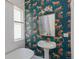 Bathroom with colorful wallpaper, pedestal sink, and classic fixtures at 2245 Julian St, Denver, CO 80211
