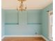 Light-filled bedroom with blue walls, decorative ceiling, and natural hardwood floors at 2245 Julian St, Denver, CO 80211