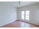Simple bedroom features hardwood floors and a bright window at 2245 Julian St, Denver, CO 80211