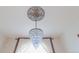 Elegant crystal chandelier with vintage ceiling medallion and window with white curtains at 2245 Julian St, Denver, CO 80211