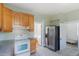Kitchen featuring stainless refrigerator, tile floors, and vintage cabinets at 2245 Julian St, Denver, CO 80211