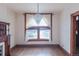 Chandelier-lit living space featuring hardwood floors, an antique fireplace and large window at 2245 Julian St, Denver, CO 80211