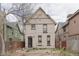 Two-story home with tan brick and visible rear entry and fenced yard at 2245 Julian St, Denver, CO 80211