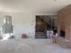 Bright and open living room with a brick fireplace, stairs, and exposed electrical at 3530 Chase St. St, Wheat Ridge, CO 80212
