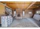 Renovated living room featuring exposed beam ceiling, brick fireplace, and stair access at 3530 Chase St. St, Wheat Ridge, CO 80212