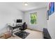 Neutral bedroom with a desk, chair, and a window letting in natural light at 2430 E 109Th Dr, Northglenn, CO 80233