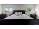 Spacious bedroom with two bright windows, neutral walls, and carpet with a dark sleigh bed at 2430 E 109Th Dr, Northglenn, CO 80233