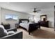 Bright bedroom features neutral carpet, ceiling fan, and a comfortable sitting area at 2430 E 109Th Dr, Northglenn, CO 80233