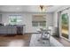 Bright dining area with hardwood floors, an elegant table, and access to the deck at 2430 E 109Th Dr, Northglenn, CO 80233