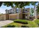Inviting townhome with a spacious two-car garage, lush green lawn, and appealing curb appeal at 2430 E 109Th Dr, Northglenn, CO 80233