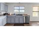 The bright kitchen features stainless steel appliances and a window with a view at 2430 E 109Th Dr, Northglenn, CO 80233