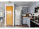 The kitchen has stainless steel appliances, grey cabinets, and a laminate countertop at 2430 E 109Th Dr, Northglenn, CO 80233