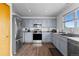 Stylish kitchen featuring stainless steel appliances, gray cabinets, and a subway tile backsplash at 2430 E 109Th Dr, Northglenn, CO 80233